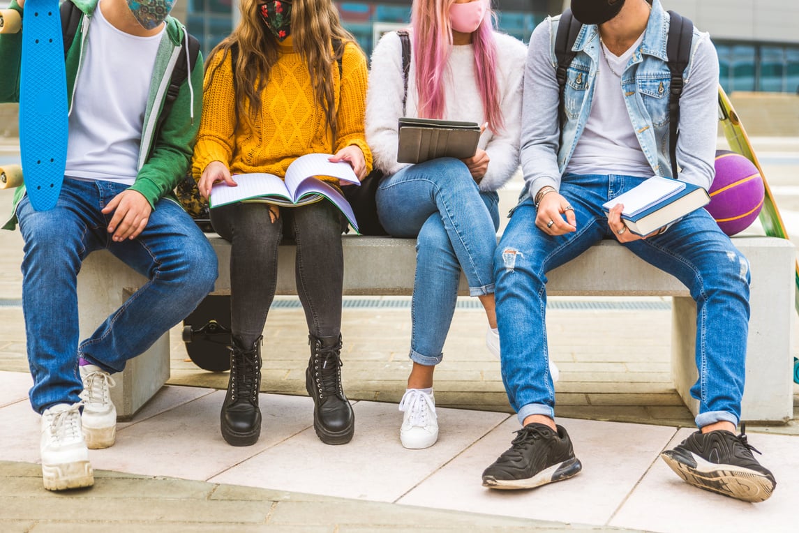 Group of young students bonding outdoors